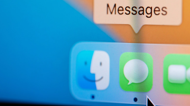 A close-up of the MacBook Dock showing black dots under certain apps.