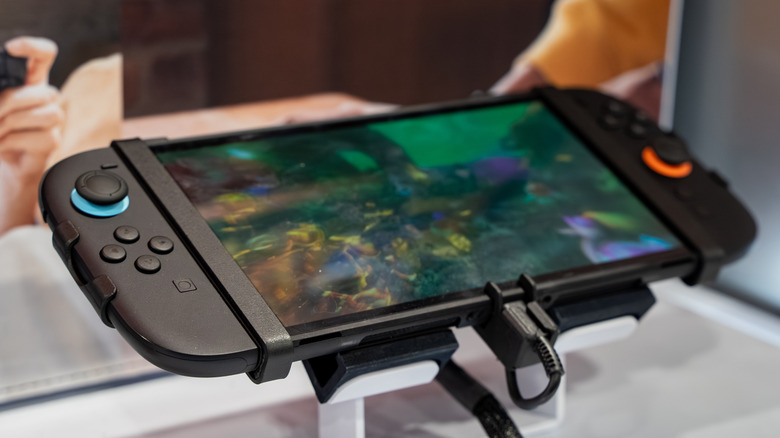 Nintendo Switch 2 console resting on a stand with a game visible on the display