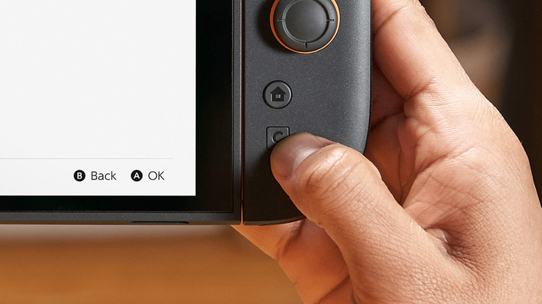 Close-up of Nintendo Switch 2 Joy-Con C button being pressed for GameChat.