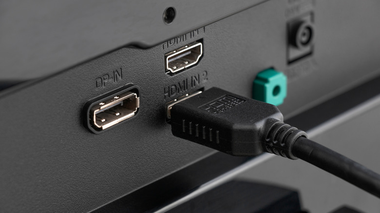 An HDMI cable connected to an HDMI port on a TV.