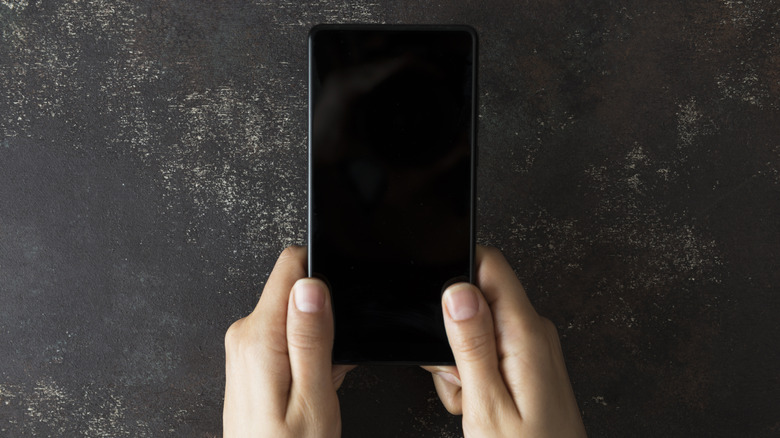 Overhead view of smartphone with screen powered off.