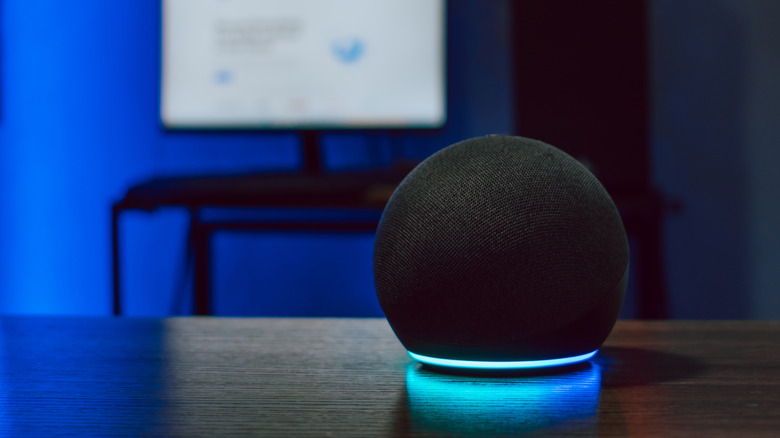 An Amazon Echo Dot with a blue LED light ring
