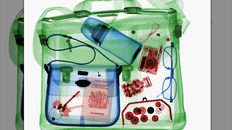 X-ray image of a bag with a baby bottle and various items