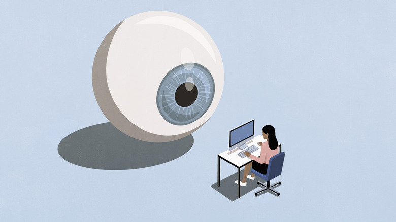 Big eyeball staring at a women on her computer at her desk.
