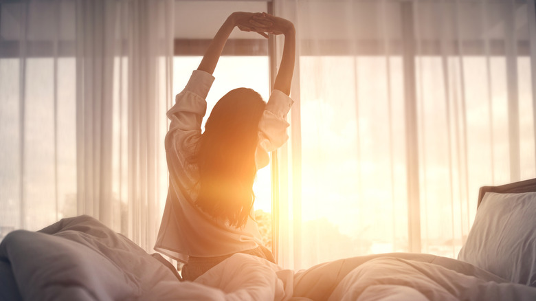 a well-rested woman waking up to daylight