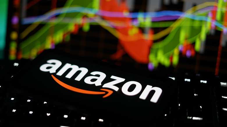 The Amazon logo with stock indices behind it.