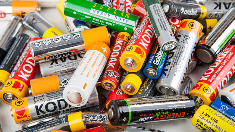 A mess of AA batteries from different brands in a pile.