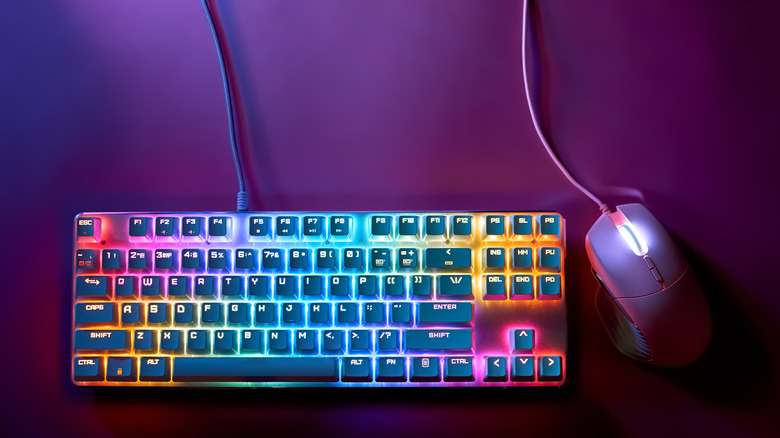 A stylish gaming keyboard with RGB lights next to a gaming mouse.