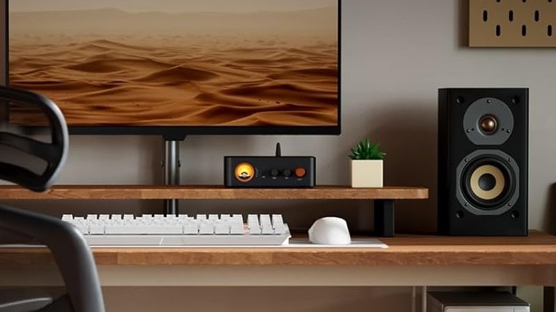 A Fosi Audio external amplifier on a desk.