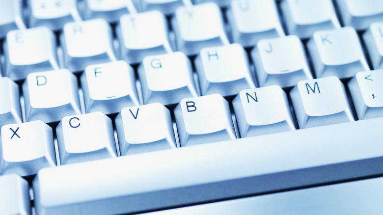 Close up of the keys on a white keyboard