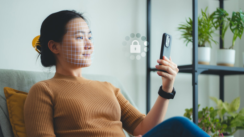 A woman using facial recognition on a phone