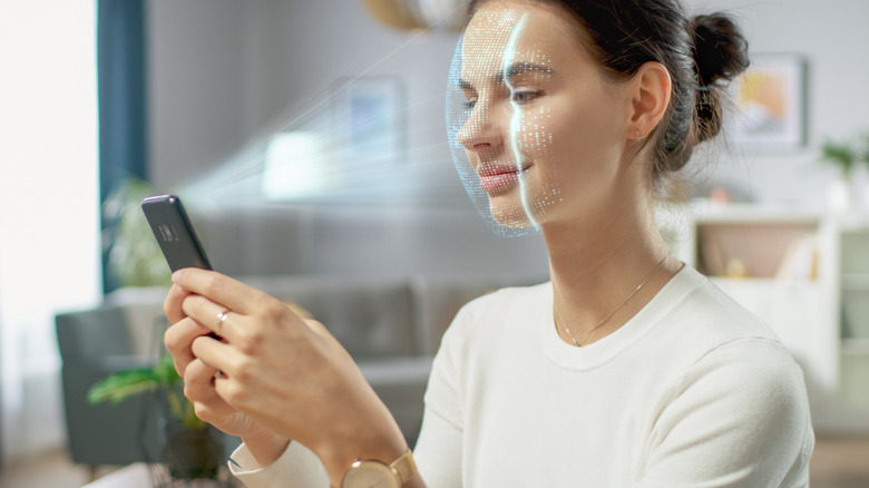 A woman using facial recognition on a phone