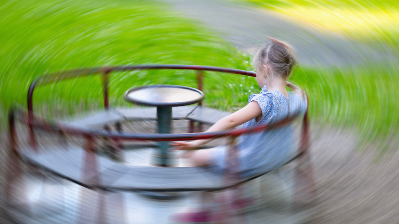 Girl spinning on carousel