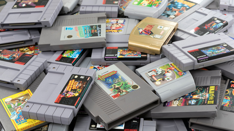 a bunch of old Nintendo games in a pile