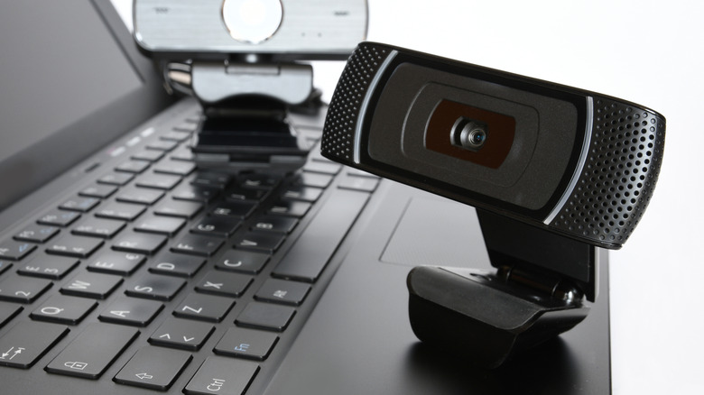 External webcam resting on top of a laptop's keyboard