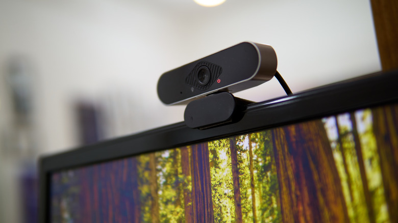 Close up of an external webcam mounted to the top of a monitor
