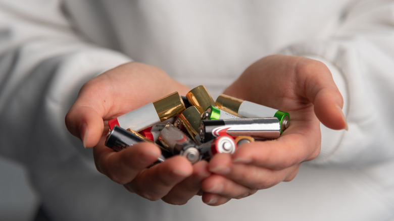 A handful of alkaline batteries from different brands