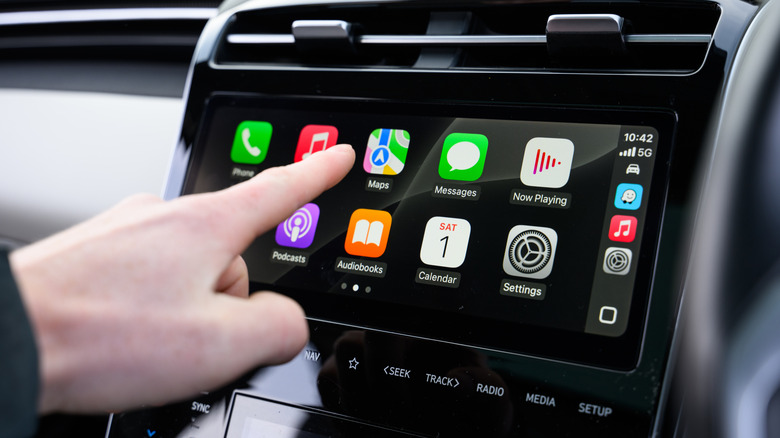 Hand Interacting with Apple CarPlay in Vehicle