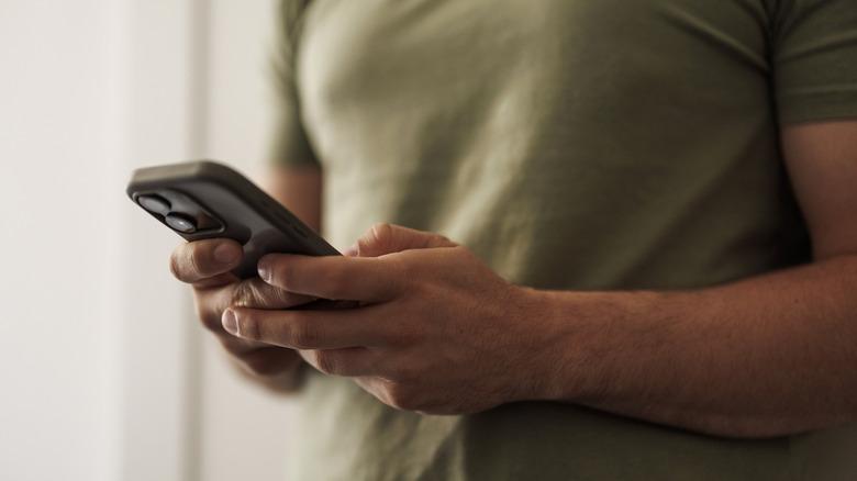 A person texting on an iPhone.