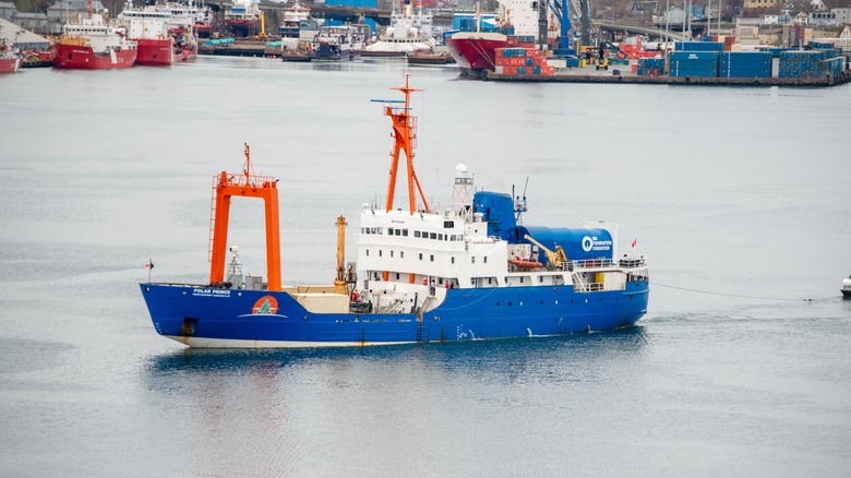 Polar Prince towing OceanGate Expeditions submersible vessels on a barge as it leaves for the Titanic wreck site to tour below the ocean.