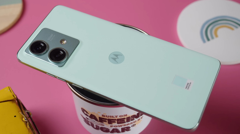 A Motorola Edge handset on a pink table