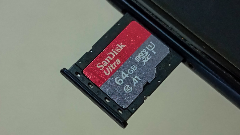 Hybrid SIM tray on a smartphone with a SIM card and microSD card