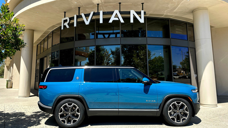 a blue Rivian EV outside of the car dealership