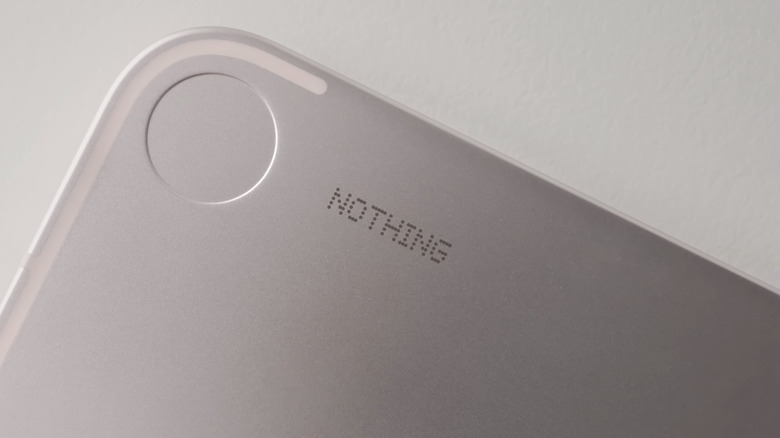 A close-up of the Nothing branding on a Nothing smartphone.