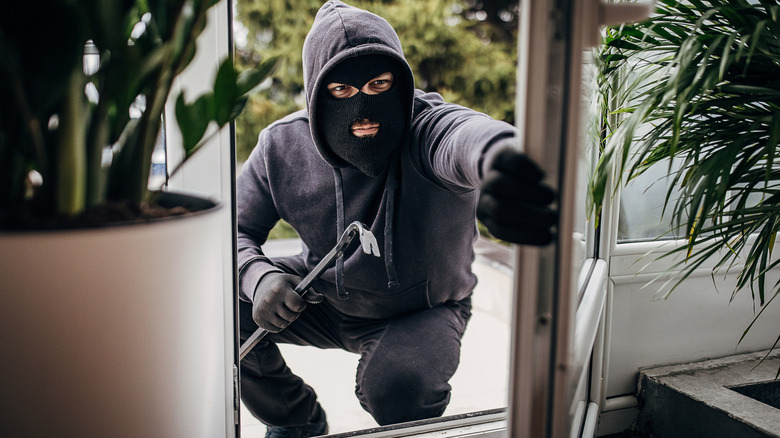 a thief breaking into a house's door