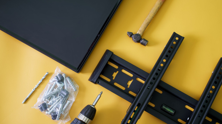 Most of the hardware and tools required for wall-mounting a TV.