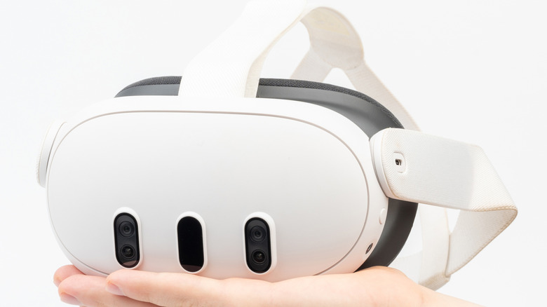 Person holding a Meta Quest 3 headset