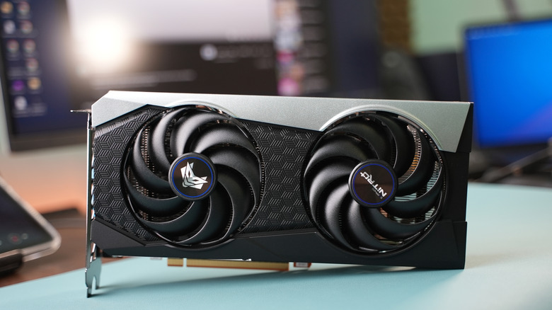 An AMD RX 6000 graphics card on a light blue desk