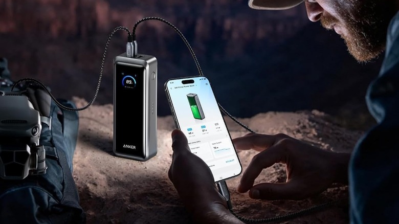 Anker Prime Power Bank 26K used to charge multiple devices outdoors.