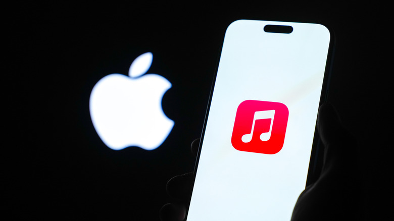 Apple Music on a phone in front of the Apple logo.