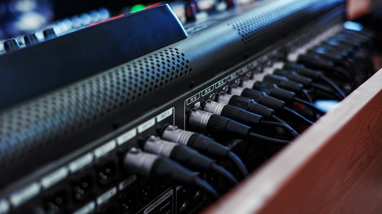 Photograph showing XLR cables plugged into a mixer.