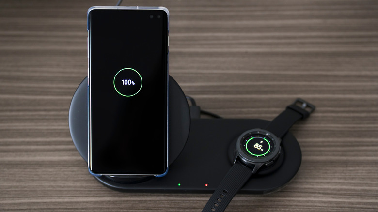 A Samsung Galaxy S10 next to a Galaxy Watch.