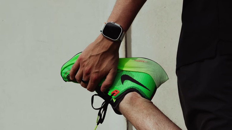 Runner stretching while wearing a Samsung Galaxy Watch Ultra