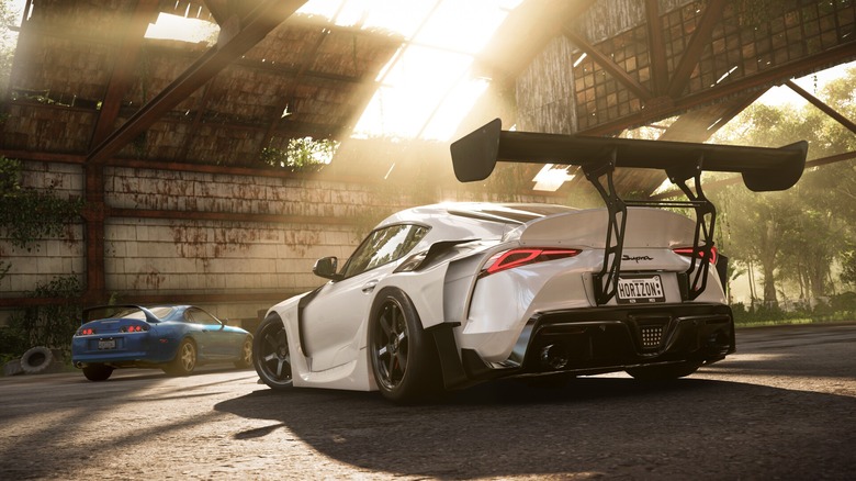 Two cars in abandoned airplane hangar in Forza Horizon 5