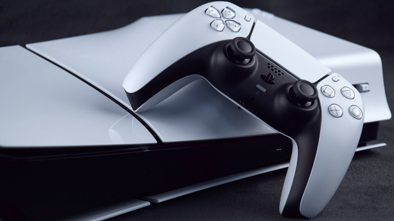 PlayStation 5 and controller on a dark table