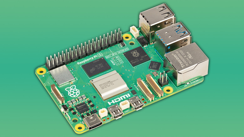 A Raspberry Pi 5 on a solid light green background.