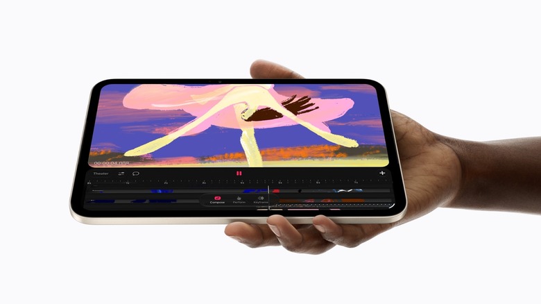 hand holding apple iPad Mini, concept showing off size of new iPad Mini
