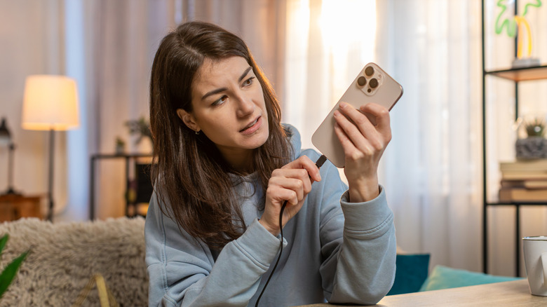 Woman looking frustrated with smartphone