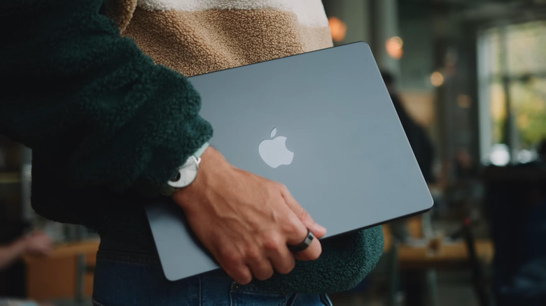 Person holding a Space Black MacBook Pro M3