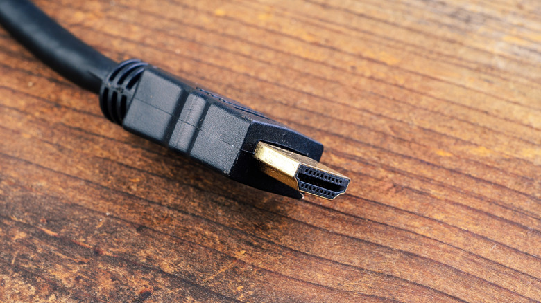 The end of an HDMI cable with connector visible, on a table.