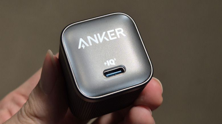 Close-up of a person holding an Anker USB-C charger in their hand