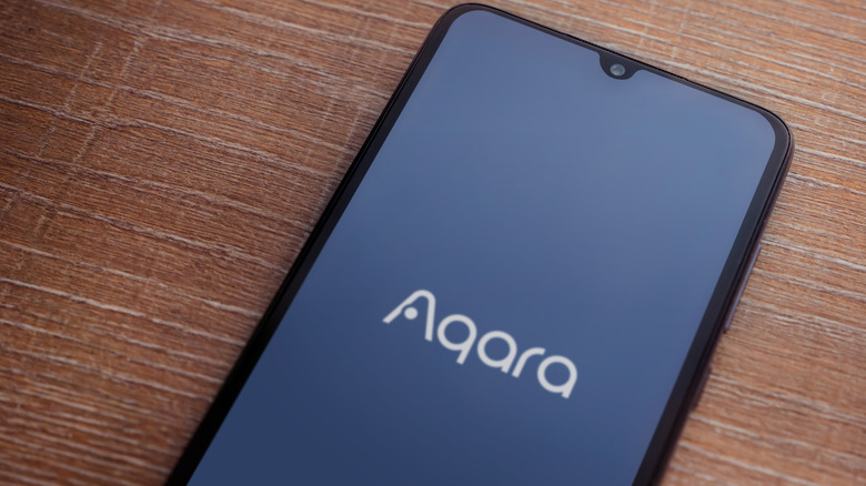 Aqara logo, shown on a smartphone screen.