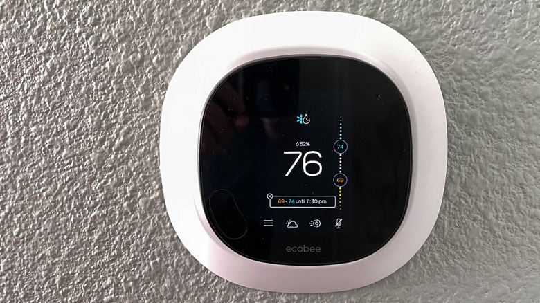 Close up of an Ecobee smart thermostat mounted to a wall.