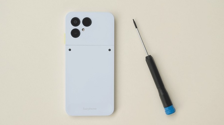 Fairphone Gen 6 phone with screwdriver next to it.