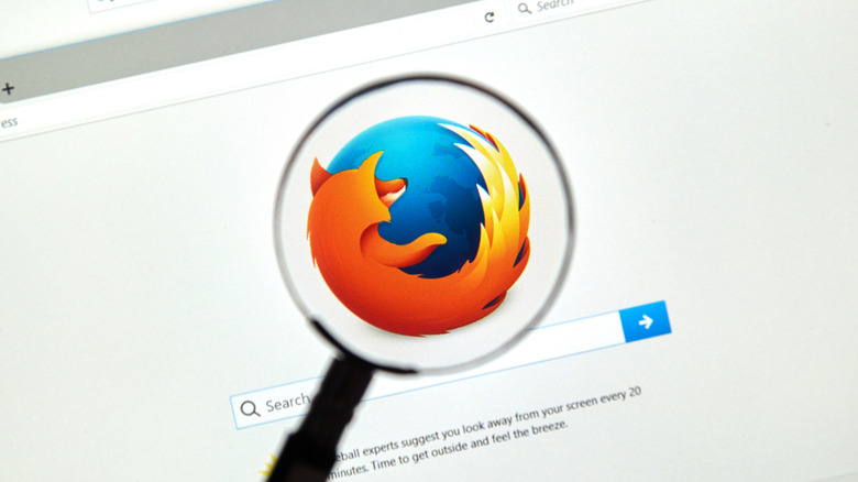 The Firefox logo under a magnifying glass.