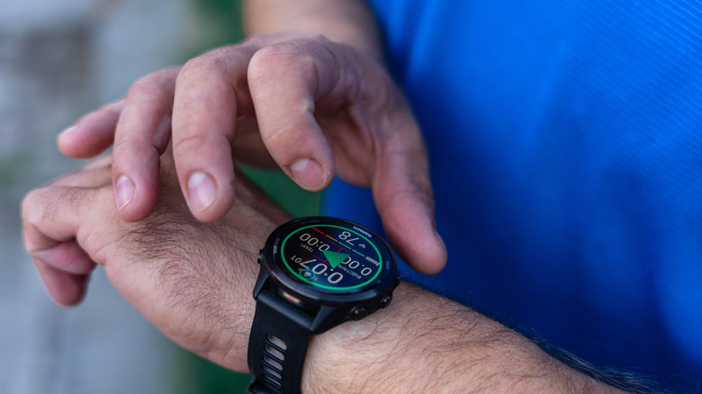 person using garmin forerunner smartwatch